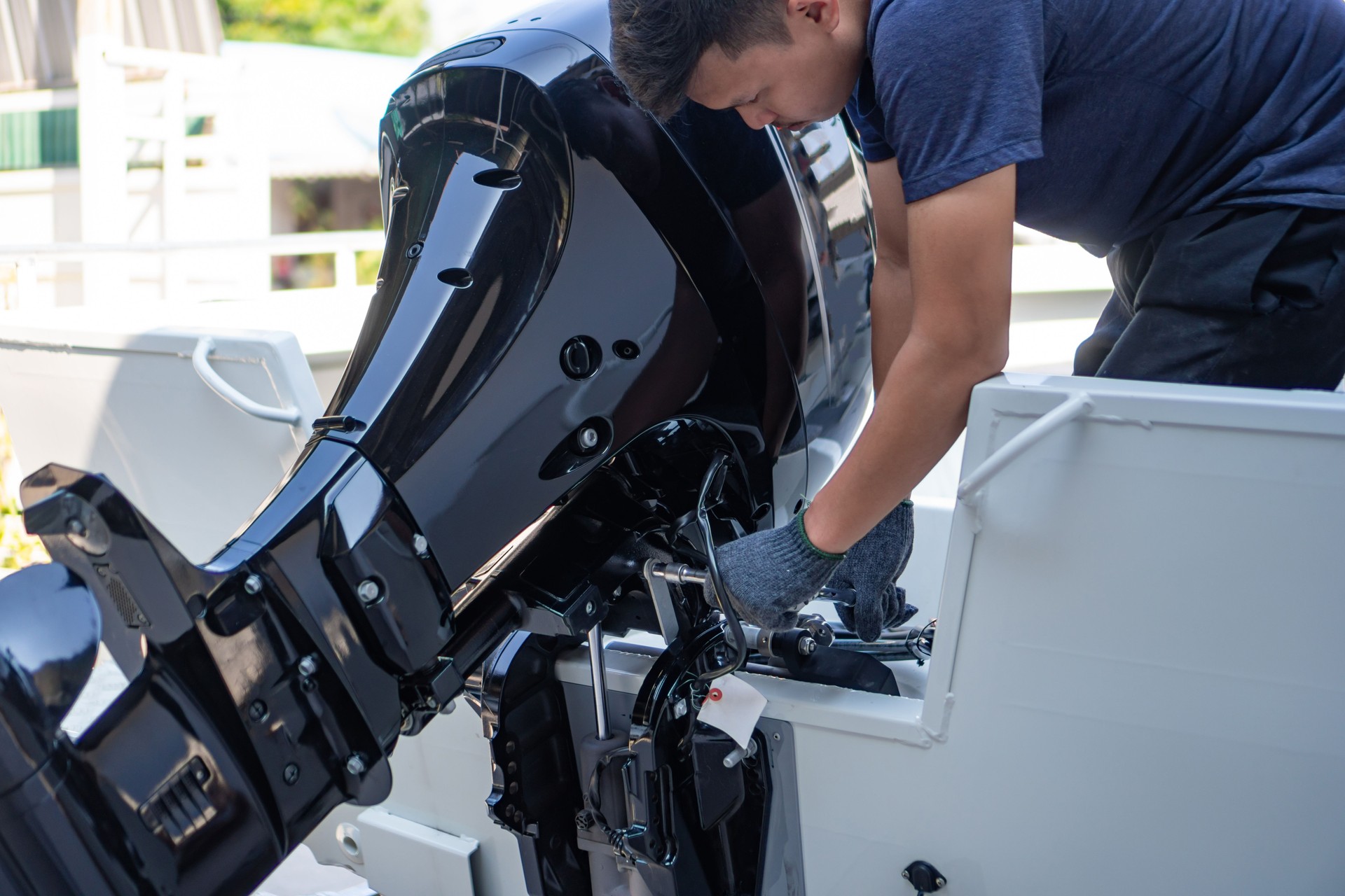 Mechanic is installing speed boat engine